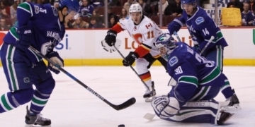Miller outshines Flames while Tanev seals deal for Canucks in OT
