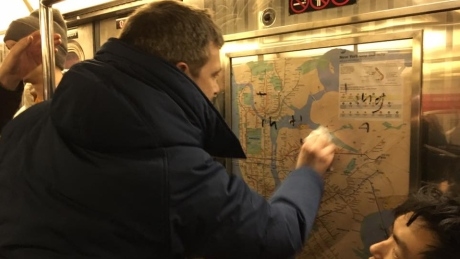 New York City commuters team up to clean Nazi graffiti in subway car