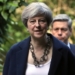 Beleaguered U.K. prime minister names new cabinet as critics circle