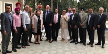 B.C. Premier John Horgan, Surrey Mayor Linda Hepner pose in photo with convicted shooter