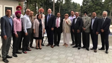 B.C. Premier John Horgan, Surrey Mayor Linda Hepner pose in photo with convicted shooter