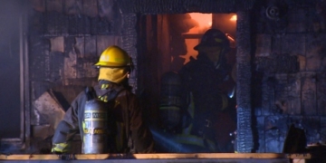 Man charged with manslaughter after body found in charred Surrey home