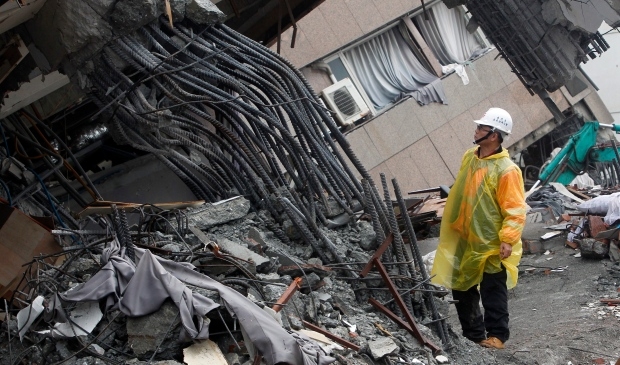 Rescuers search tilted building in Taiwan as quake death toll hits 10