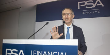 Peugeot maker sees record profit, but virus clouds horizon