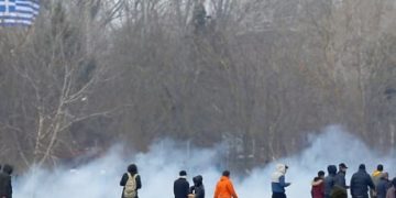 Greek and Turkish police fire tear gas as migrants try to cross into Greece