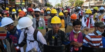 Defying deadly crackdown, protesters in hard hats and goggles clash with riot police in Myanmar