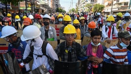 Defying deadly crackdown, protesters in hard hats and goggles clash with riot police in Myanmar
