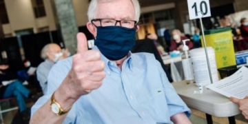 Former prime ministers quietly line up with the crowds for their COVID-19 shots