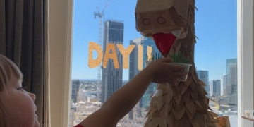 This family built a massive dinosaur out of take-out containers during their hotel quarantine