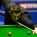 Selby edges ahead at Crucible as semi-final paused for overrunning