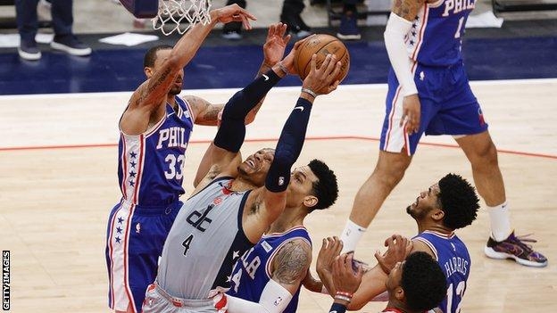 Wizards beat 76ers to keep series alive as fan banned for court invasion